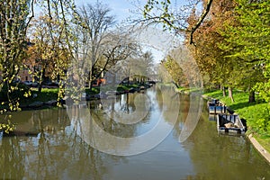 The canal or Singel in Utrecht The Netherlands on a sunny spring day with trees and boats