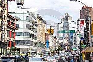 Canal Street is packed with cars while crowds of people shop along the sidewalks in New York City