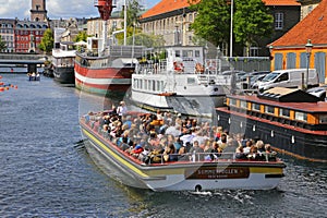 Canal tourboat on sightseeing trip on canal in Copenhagen, Denmark