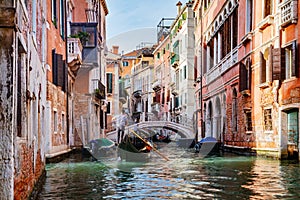 Canal in Venice, Italy with gondolier rowing gondola