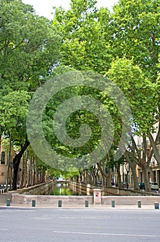 Canal of water leading to a fountain and gardens photo