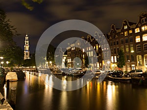 Canal With Westerkerk In Amsterdam At Night