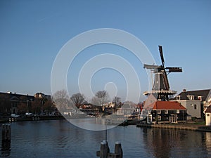 A canal and windmill view in Haarlem