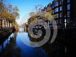 Canals, bikes and houses of Amsterdam city, in Holland, Netherlands