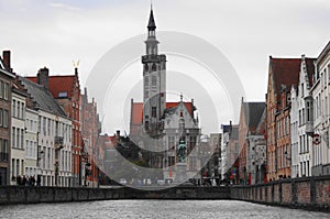 The canals of Brugge with Jan Van Eyck Square in Bruges Belgium