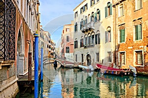 Canals with reflections, bridge and gondola, Venice, Italy