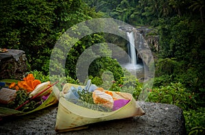 Canang Sari in front of Tegenungan Waterfall photo