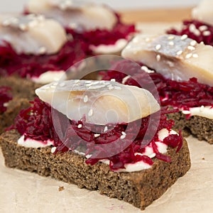 Canape with a pickled herring and beetroot