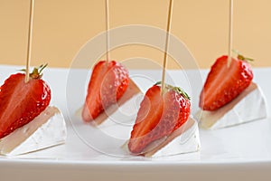 Canape with strawberries and camembert cheese