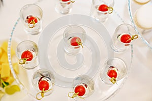 canapes with cherry tomato, mozzarella and olive in cups