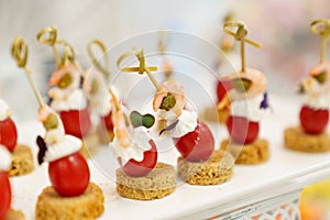 canapes with cherry tomato, shrimp and capers.