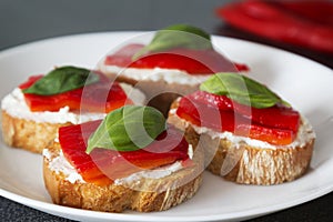 Canapes with roasted peppers, cream cheese and basil