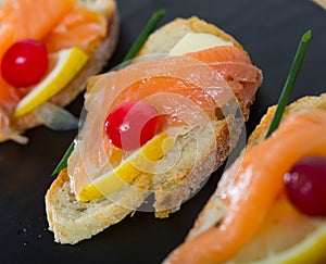 Canapes with salmon, butter and cranberries
