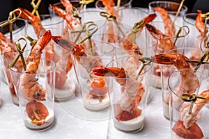 Canapes with tomatoes, shrimp and buttercream on a large plate