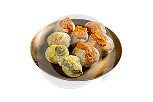 Canary Islands dish Papas Arrugadas wrinkly salty potatoes with and Mojo picon red spicy sauce. Isolated on white