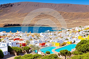 Canary Islands (Spain), La Graciosa . Caleta del Sebo village and la Aguja Grande Volcano, view from the sea photo