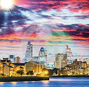 Canary Wharf night skyline with Thames river reflections, London