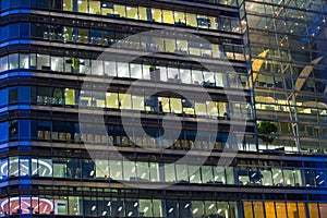 Canary Wharf office's windows lit up at dusk, Business life concept background