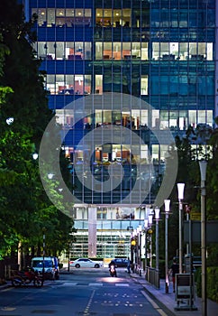 Canary Wharf office's windows lit up at dusk, Business life concept background