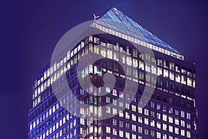 Canary Wharf office's windows lit up at dusk, Business life concept background