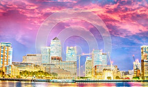 Canary Wharf skyscrapers. Panoramic sunset view with water reflections