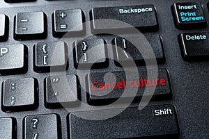 Cancel culture enter key on the black pc keyboard. Concepts of ostracism and call-out culture in the Internet and on social media