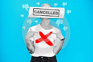 Cancel culture, woman and text overlay with graphic and bad emoji for social media ban in studio. Blue background, cross