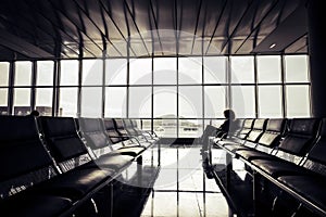 Cancel delay flight at the airport concept with alone traveler waiting sit down on the seats - travel and gate time - modern