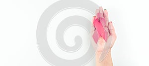 Cancer awareness. Health care symbol pink ribbon in woman hands on white background. Breast woman support concept. World
