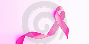 Cancer day. Health care symbol pink ribbon on white background. Breast cancer woman support concept with copy space.