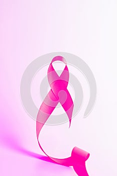 Cancer day. Health care symbol pink ribbon on white background. Breast cancer woman support concept with copy space.