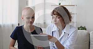 Cancer patient listen doctor holding tablet showing chemo test results