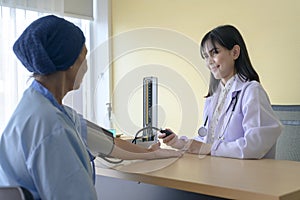 Cancer patient woman wearing head scarf after chemotherapy consulting and visiting doctor in hospital