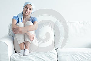 Cancer survivor sitting on sofa