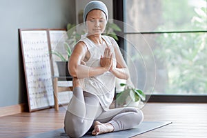 Cancer woman doing yoga at home