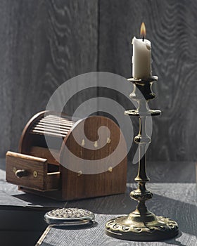 Candelabra with candle, inlaid jewelry box, women`s mirror.