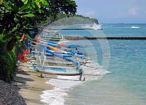 Candi Dasa beach with traditional outrigger fishing boats in Bali, Indonesia. photo
