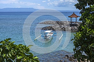 Candi Dasa beach with traditional outrigger fishing boats in Bali, Indonesia. photo