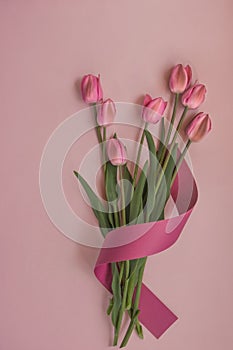 Candid bouquet of pink tulips on pastel background