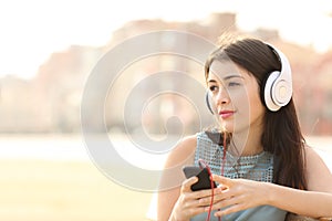 Candid girl listening music with a smartphone photo