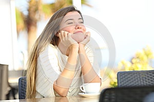 Candid girl relaxing in a coffee shop terrace