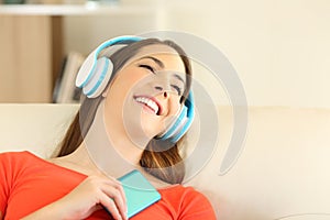 Candid girl wearing headphones listening to music photo