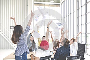 Candid group of young creative team employee prople throwing documents paper and feeling happy after work success at working place