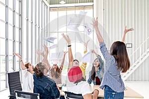 Candid group of young creative team employee prople throwing documents paper and feeling happy after work success at working place