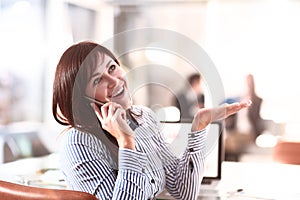 Candid image of a businesswoman working in a cafe.