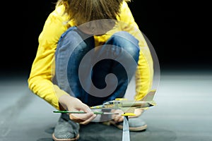 candid little six year old kid boy painting or colorize or colour model airplane with gouache paints