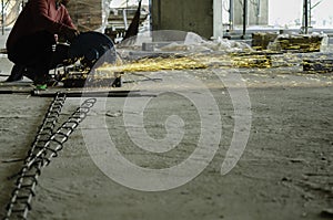 candid metal cutting saw slicing through a steel bar in Construction Site, Copy space On the bottom right