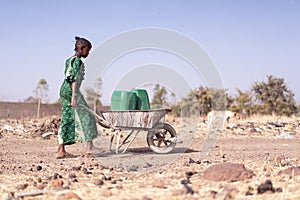 Candid photo of Aboriginal Woman Bringing fresh Water in a typical village