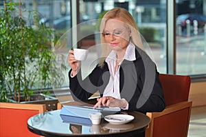 Candid photo of a atractive middle-aged blond businesswoman working