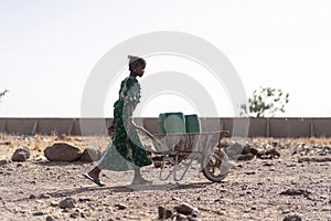 Candid photo of West Africa Women getting Tap Water in an arid zone